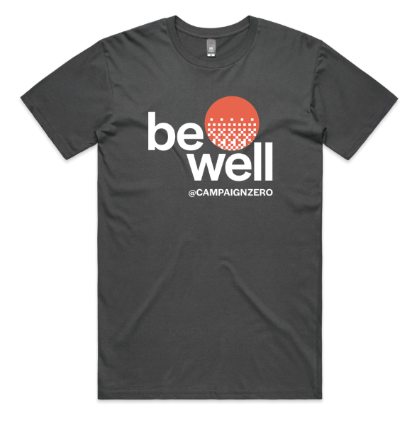 The Solid Cotton Tee by Campaign Zero features a black design with "be well" and "@CAMPAIGNZERO" printed in white, along with an orange dotted circle above the text. This premium cotton T-shirt is made from heavyweight material and is available in unisex sizes.